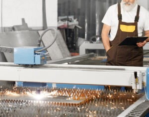 engineer observing plasma laser cutting metal sheet